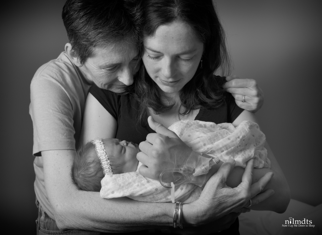 Grandma holding mom who's holding her baby