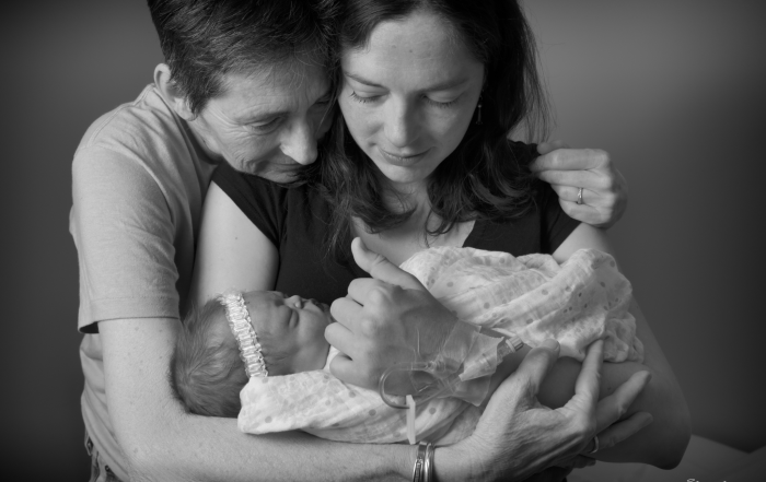 Grandma holding mom who's holding her baby